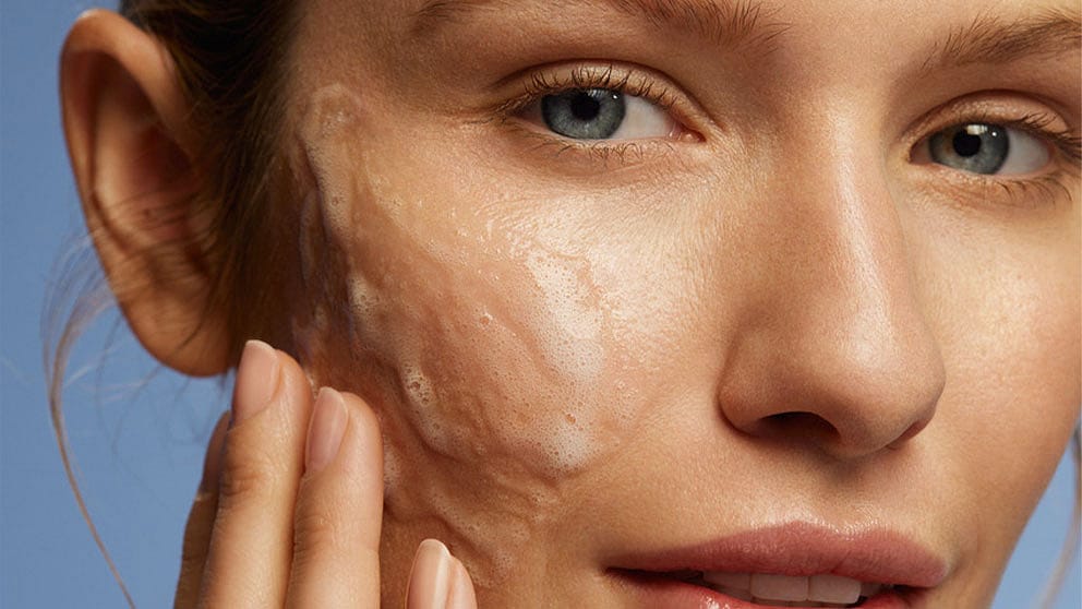 woman cleaning face